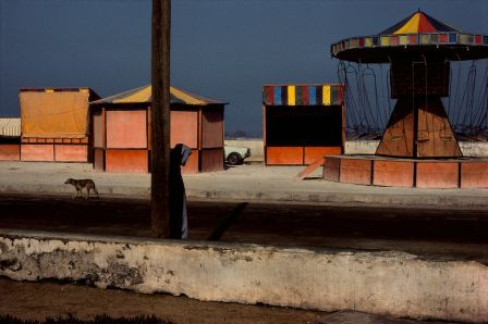 MOROCCO. Essaouira. Amusement stands near the beachfront. 1988.© Harry Gruyaert / Magnum Photos