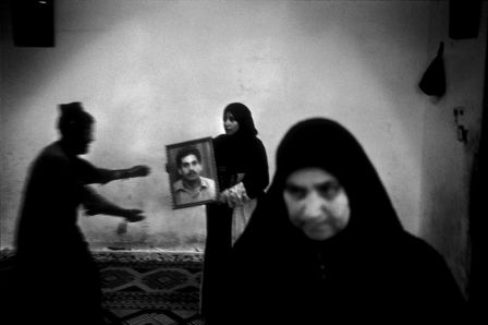 Ashraf Abu Lipta's family holds the picture of their son, a local leader of the Palestinian Popular front, killed in February 2004 by an IDF targeted assassination operation in Rafah.© Paolo Pellegrin/Magnum Photos